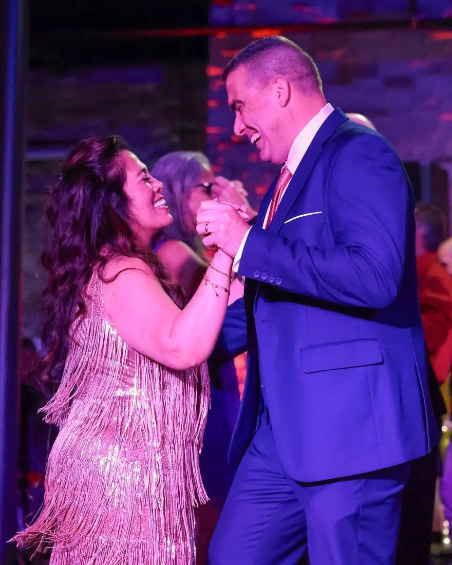 A couple dancing cheek to cheek at an Effervescent Studios showcase night
