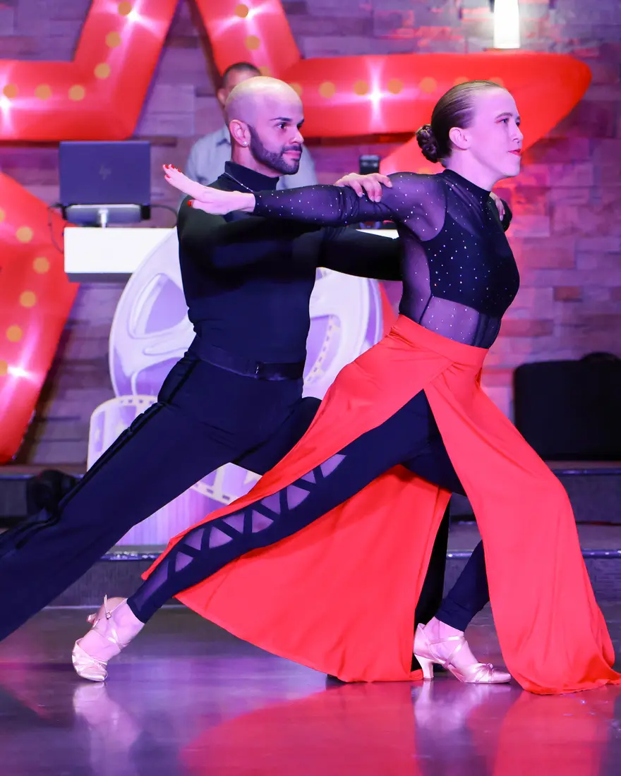 Two dancers in a ballroom hold on the floor at Effervescent Studios